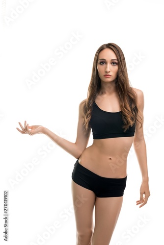 Slim girl in black top and shorts isolated view © Wisky