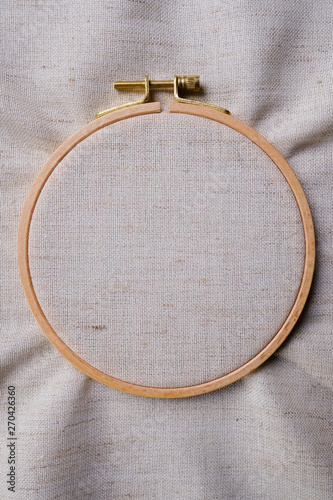 White blank canvas on wooden round frame as a background. Flat lay top view of a mockup
