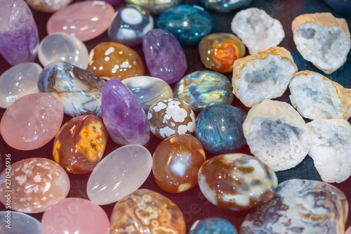 Heap of various colored gems. Colorful gemstones. Natural Polished Gemstone Semi Precious Rocks Colorful Background Texture Close Up Phot. vertical photo