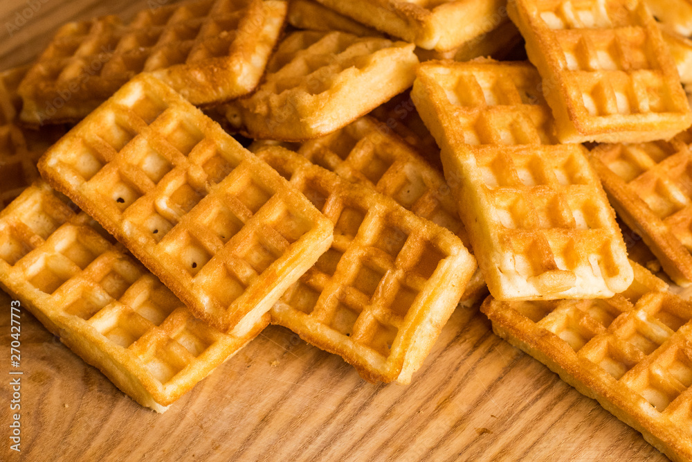 close up of many Belgian waffles on the wooden table close up of many Belgian waffles on the wooden table