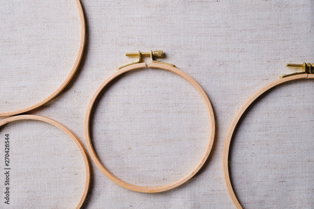 The embroidery hoops for needlework and sewing Flat lay top view of a mockup on canvas background The embroidery hoops for needlework and sewing Flat lay top view of a mockup on canvas background