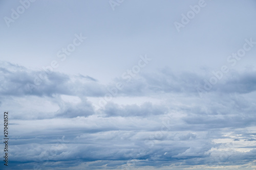 Blue sky background with tiny fluffy clouds. With copy space for text