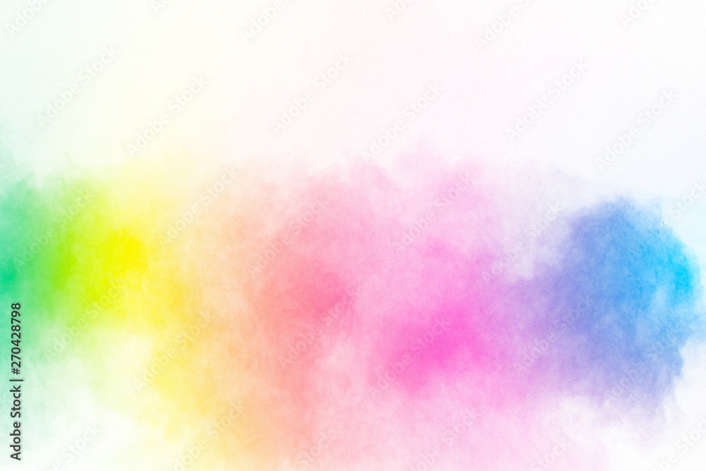 Multicolored powder explosion on white background.Launched colorful particles on background.