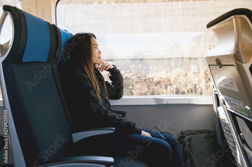 Photography Beautiful young asian woman sitting on the express train from narita airport go