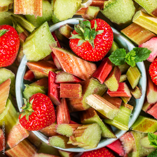 Close up of Pieces of Raw and Freshly Cut Rhubarb and Strawberries  Background Image