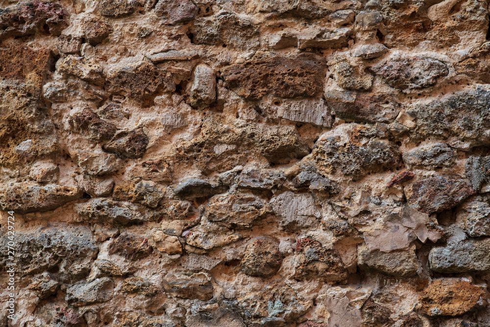 Obraz premium Background of a medieval wall made of old rustic stone