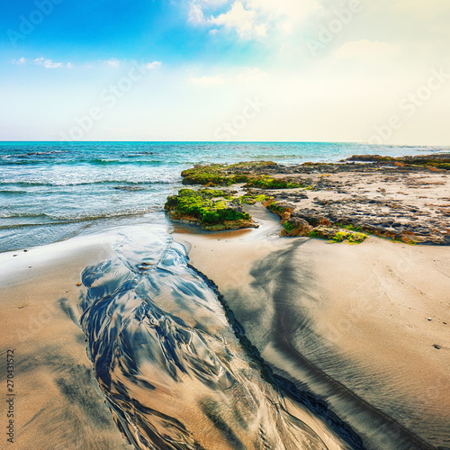 Picturesque seascape with white rocky cliffs, sea bay, islets and faraglioni near by Frassanito Beach, photo