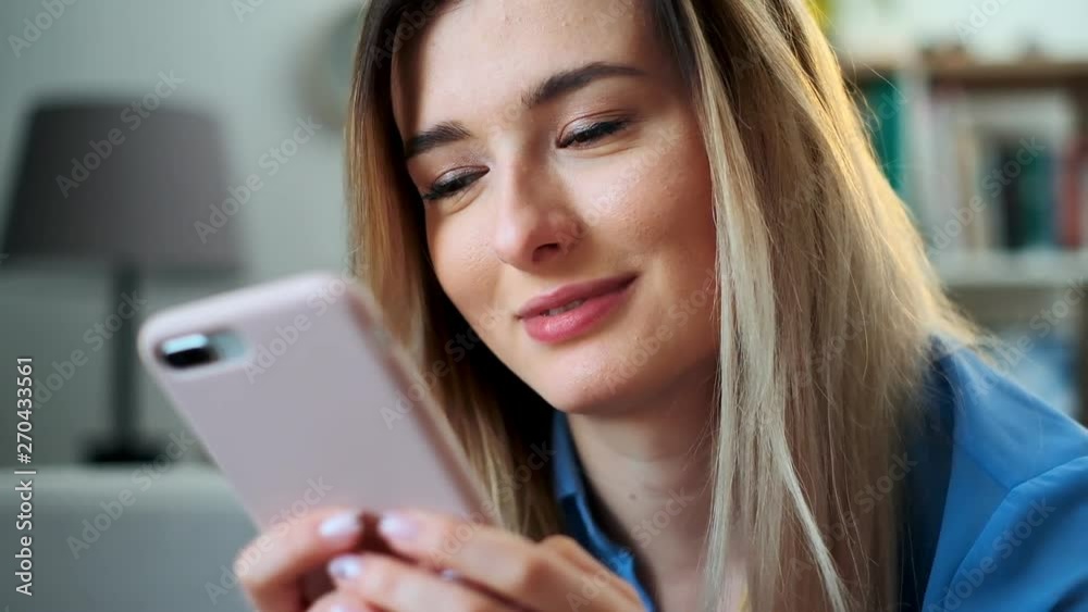 Close up portrait of girl using mobile device browsing the internet, staying connected at home enjoying modern lifestyle. Pretty young woman using smartphone on the couch, texting while relaxing. Close up portrait of girl using mobile device browsing the internet, staying connected at home enjoying modern lifestyle. Pretty young woman using smartphone on the couch, texting while relaxing.