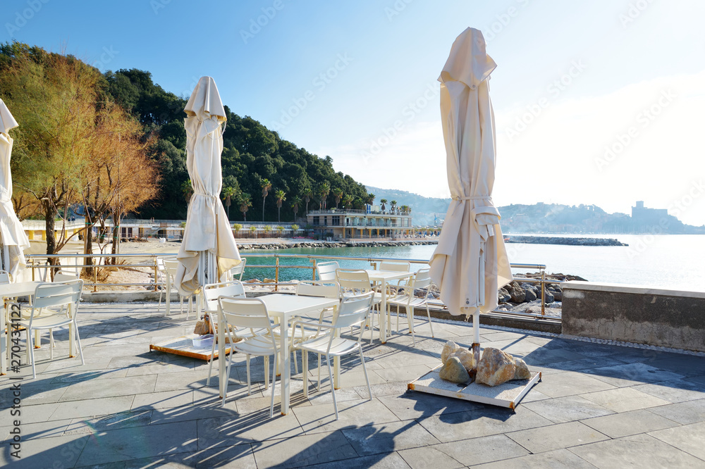Fototapeta premium Outdoor restaurants and cafes on a seafront of Lerici town, a part of the Italian Riviera, Italy.