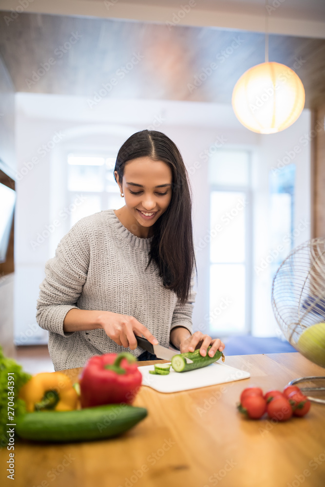 Young woman cooking. Healthy food vegetable salad. Diet. Dieting concept. Healthy lifestyle. Cooking at home. Prepare food