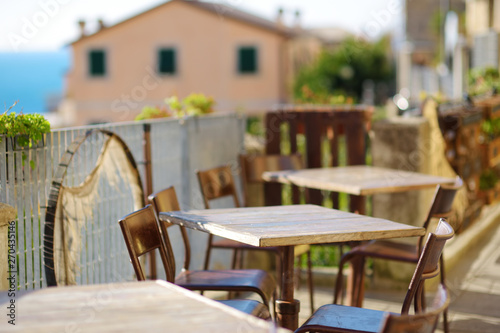 Beautifully decorated small outdoor restaurant tables in Riomaggiore village  Cinque Terre  Italy