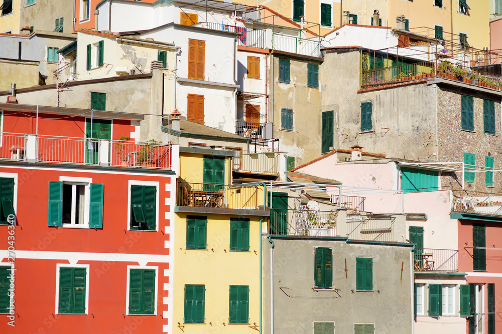 Pastel houses of Riomaggiore, the largest of the five centuries-old villages of Cinque Terre, Italian Riviera, Liguria, Italy. Pastel houses of Riomaggiore, the largest of the five centuries-old villages of Cinque Terre, Italian Riviera, Liguria, Italy.