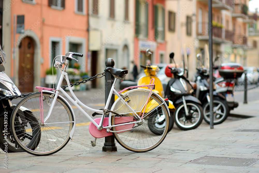 Row of bicycles parked on beautiful medieval streets of Bergamo, Lombardy, Italy.