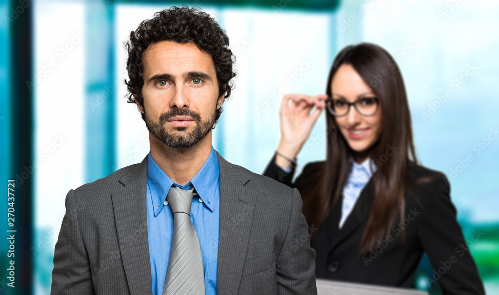 Business partners smiling in a modern office Business partners smiling in a modern office