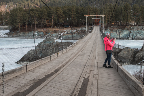 Happy woman taking photos o...