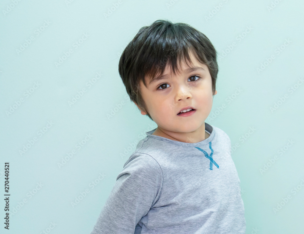 Protrait of happy kid boy looking at camera with smiling face, Indoor portrait of Child with green background Protrait of happy kid boy looking at camera with smiling face, Indoor portrait of Child with green background
