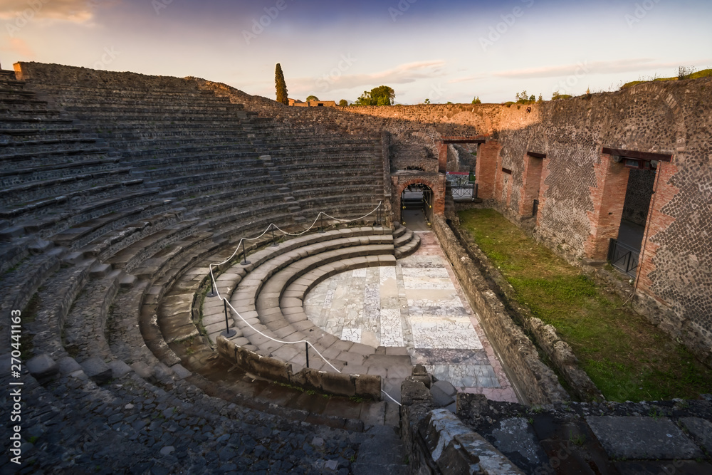 Ruins of amphitheatre at sunset, Pompeii, ancient roman city near Vesuvius volcano, Italy