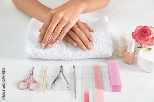 Woman waiting for manicure and tools on table  closeup. Spa treatment