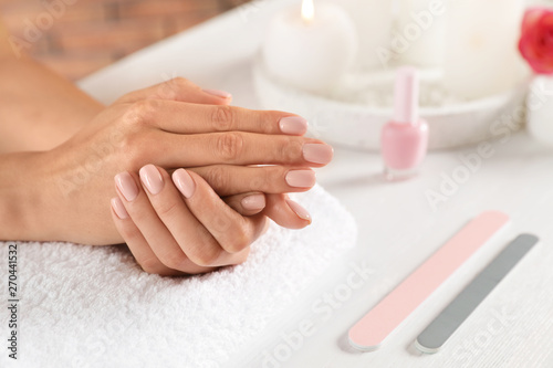 Woman waiting for manicure at table, closeup with space for text. Spa treatment