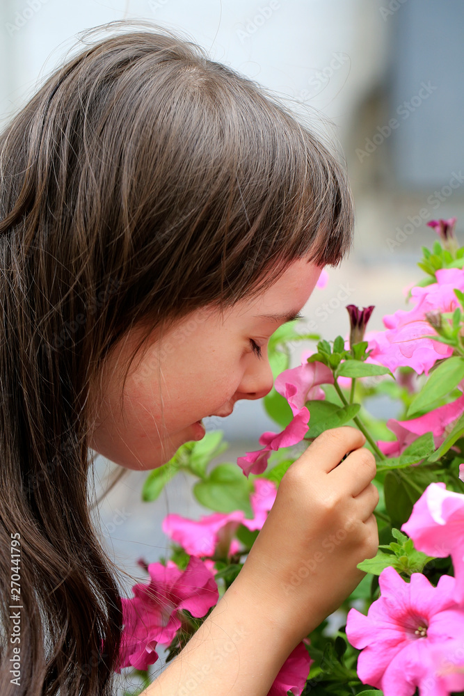 Fototapeta premium Little girl speaking with flower