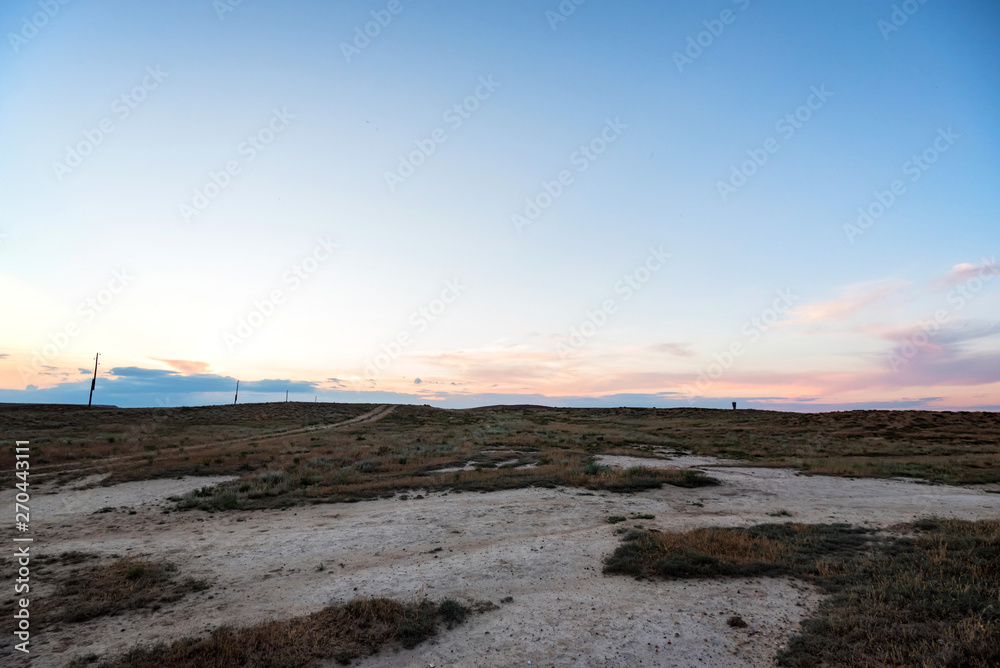 Semi-desert landscape with rural road and sky Semi-desert landscape with rural road and sky