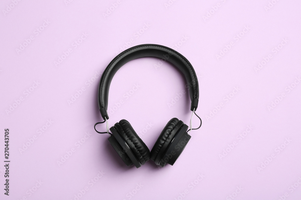 Fototapeta premium Stylish headphones on color background, top view