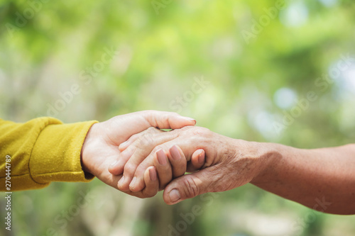 young and old woman hand holding each other ,helping hand concept  © doucefleur