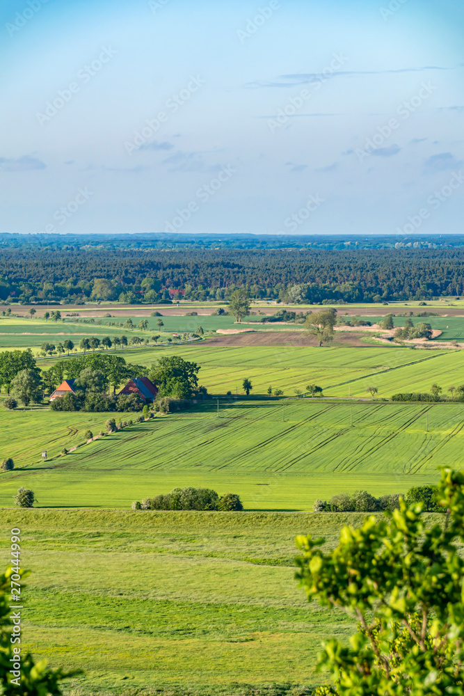 View over the Elbauen in Lower Saxony, Germany. You see a landscape with fields, meadows and trees. View over the Elbauen in Lower Saxony, Germany. You see a landscape with fields, meadows and trees.