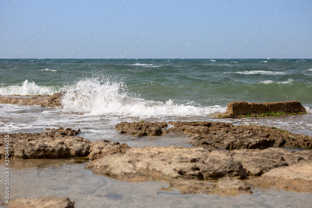 Sea waves and the ruins of the ancient port Sea waves and the ruins of the ancient port
