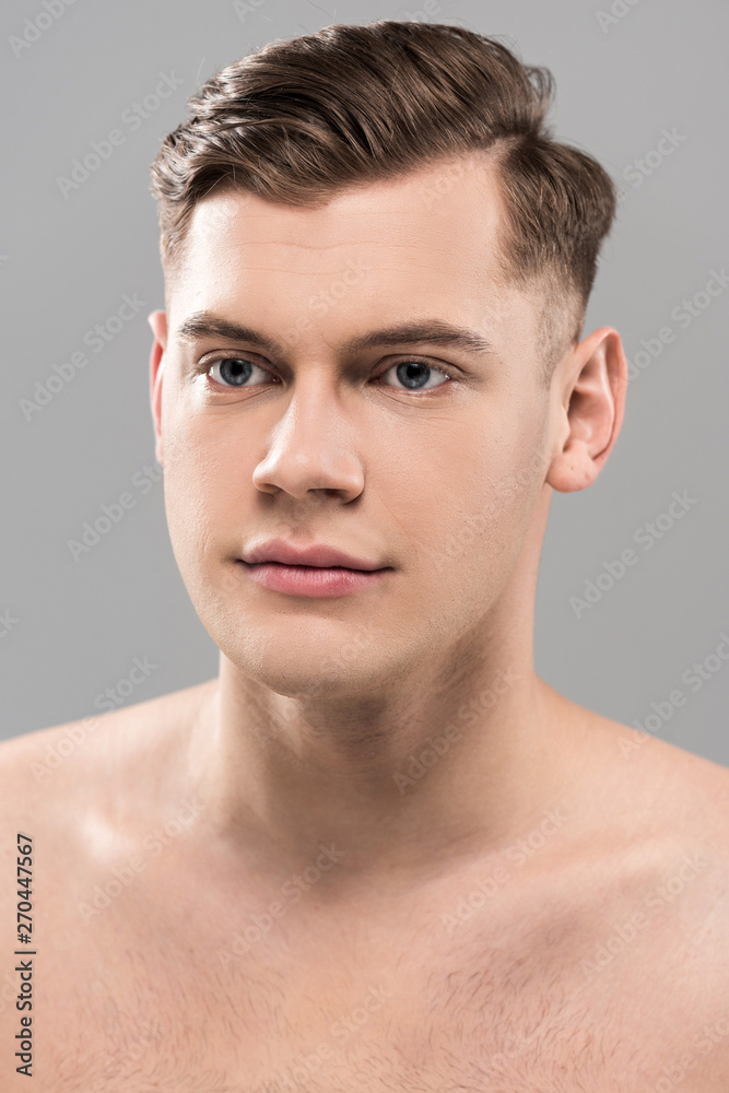 nude handsome young man looking away isolated on grey nude handsome young man looking away isolated on grey