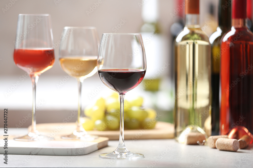 Different glasses with wine served on table