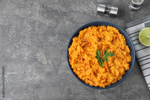 Flat lay composition with mashed sweet potatoes on grey background, space for text