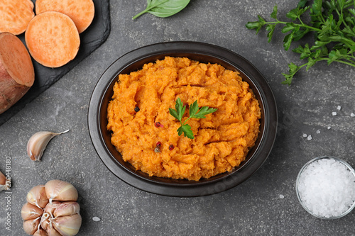 Flat lay composition with mashed sweet potatoes on grey background