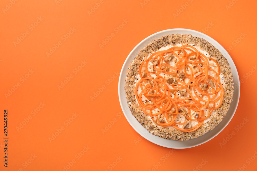 Dish with delicious carrot cake on color background, top view. Space for text Dish with delicious carrot cake on color background, top view. Space for text