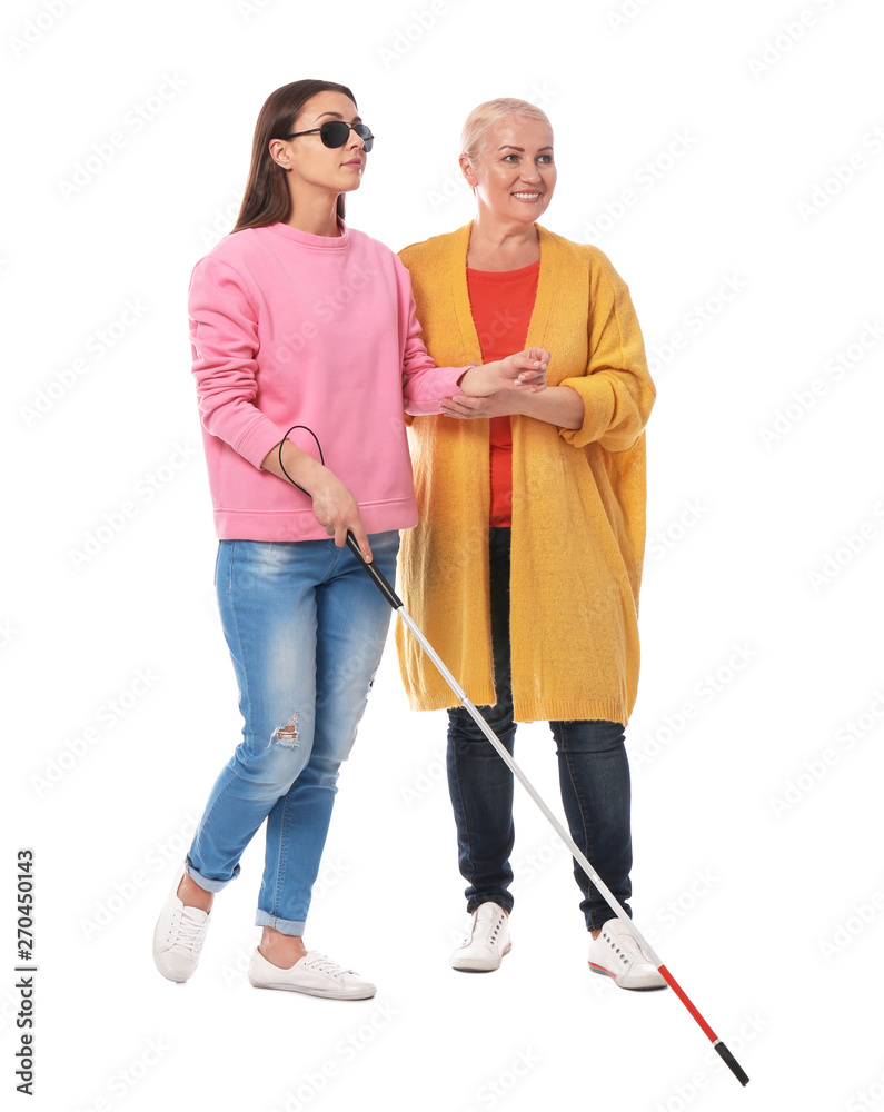 Mature woman helping blind person with long cane on white background Mature woman helping blind person with long cane on white background