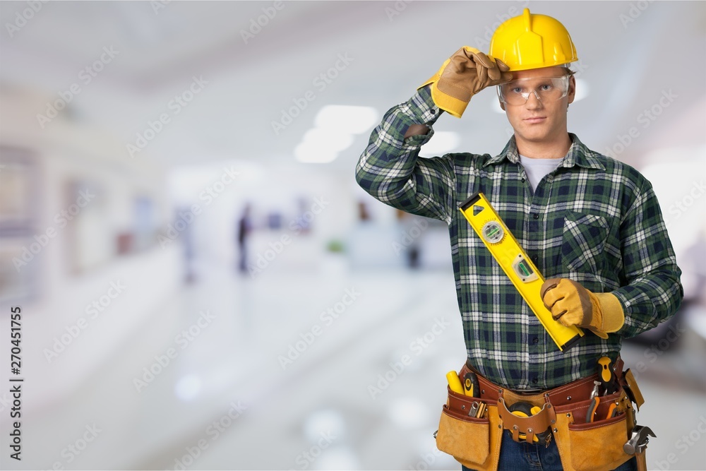 Male worker with tool belt isolated on background Male worker with tool belt isolated on background