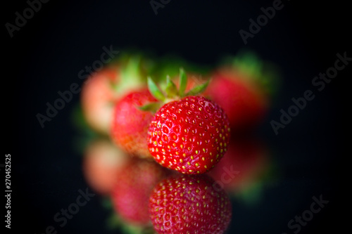 ripe red strawberries on a black background