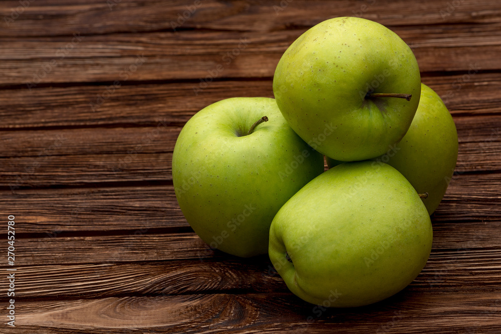 Green apples on dark brown wooden background. Summer fruits. Natural vitamins. Healthy food. Green apples on dark brown wooden background. Summer fruits. Natural vitamins. Healthy food.