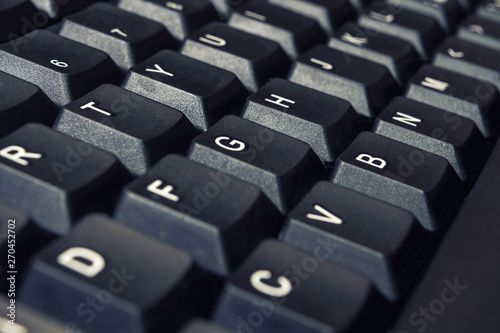 Black Computer keyboard buttons with English letters closeup.