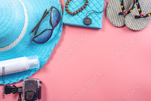 Travel holiday supplies: hat, sunglasses, camera passport and airline tickets on pink background. Top view. Flat lay