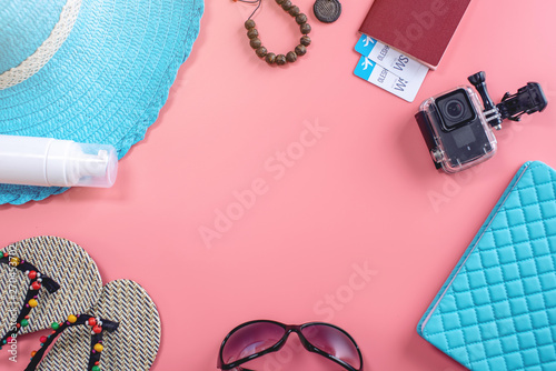 Travel holiday supplies: hat, sunglasses, passport on pink background. Concept of going on vacation at sea. Top view
