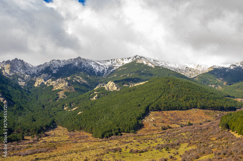 Landscape of Cuerda Larga mountain range with snow in the summits