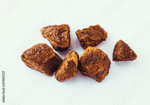Fried sauteed beef tenderlion cubes isolated on white background photo