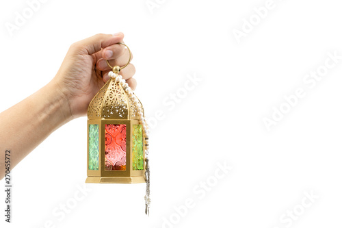 Hand holding arabic lantern isolate on white. Selective focus