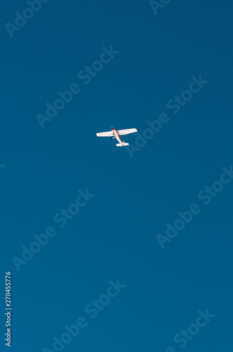 An airplane in the blue sky flying