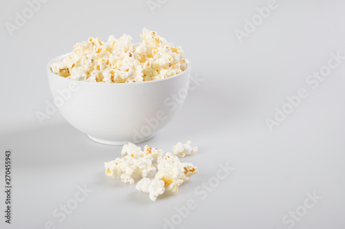 Popcorn in a bowl, isolated on white.