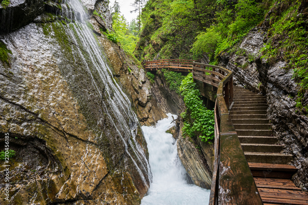 A lot of Waterfalls in the Wimbacklamm in Bavaria Berchtesgaden with stones and green plants and trees A lot of Waterfalls in the Wimbacklamm in Bavaria Berchtesgaden with stones and green plants and trees