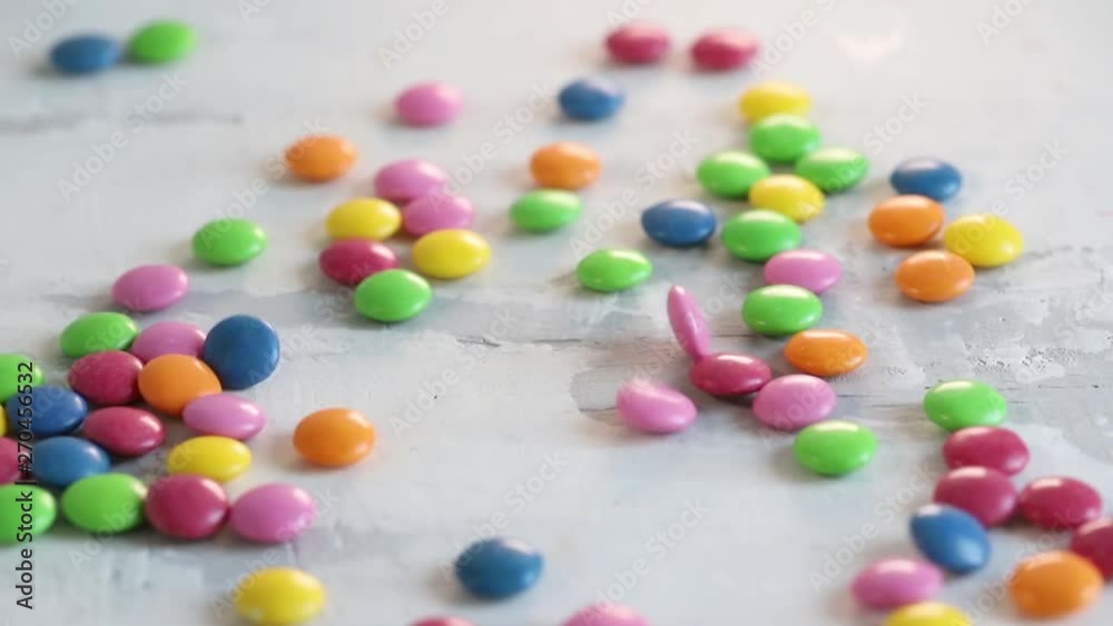 falling close up candy drops on white wooden background falling close up candy drops on white wooden background