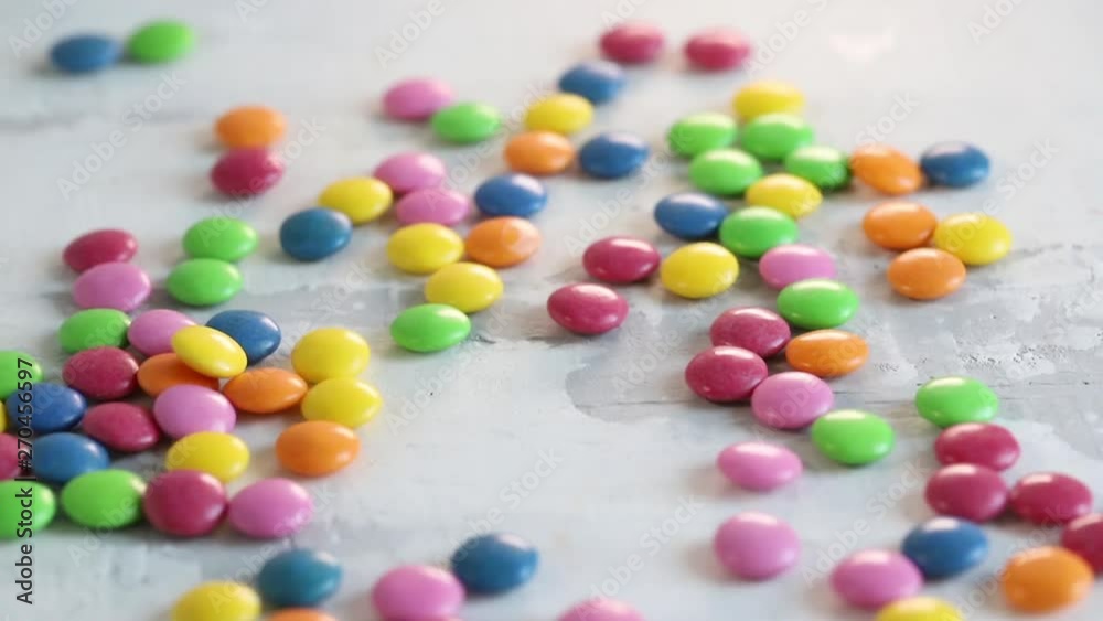 falling close up candy drops on white wooden background falling close up candy drops on white wooden background
