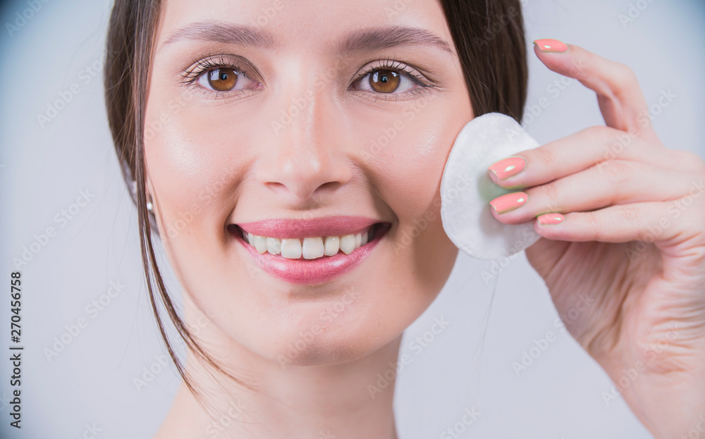 Woman using cotton pad. Healthy skin brunette woman closeup face clean healthy skin Woman using cotton pad. Healthy skin brunette woman closeup face clean healthy skin